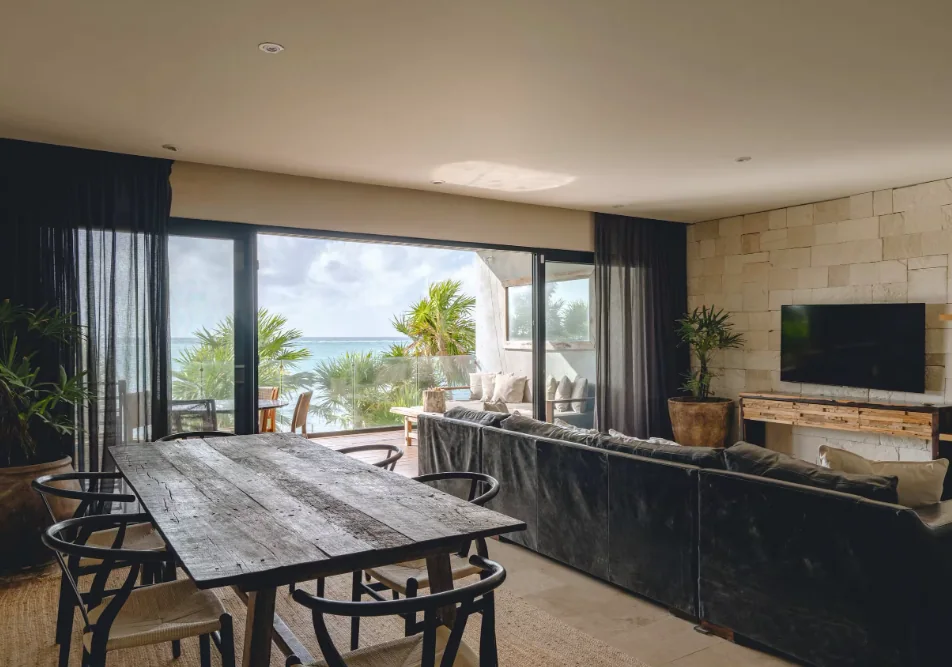 Open-plan living and dining area with ocean views in unit 104