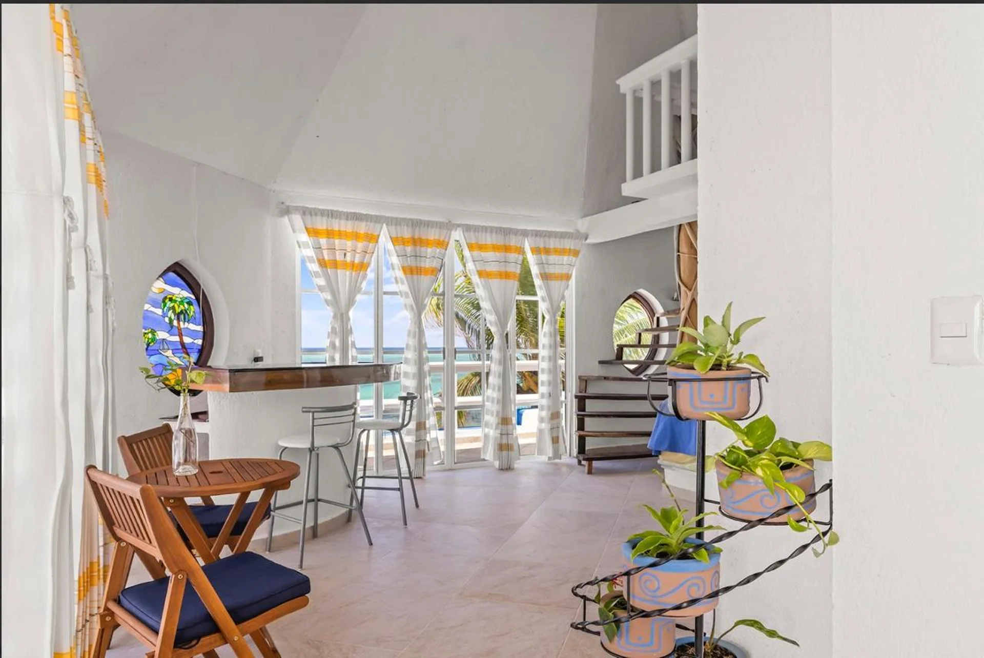 Sala y bar con vitral y vista al mar en villa Casa Cenote, Bahía Tankah Tulum