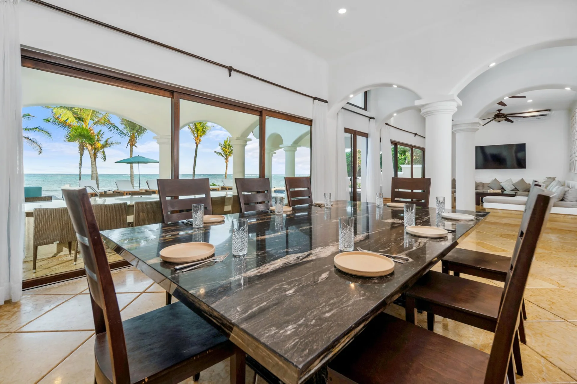 Interior dining room with black granite table and Caribbean Sea views, Hacienda Caracol Tulum