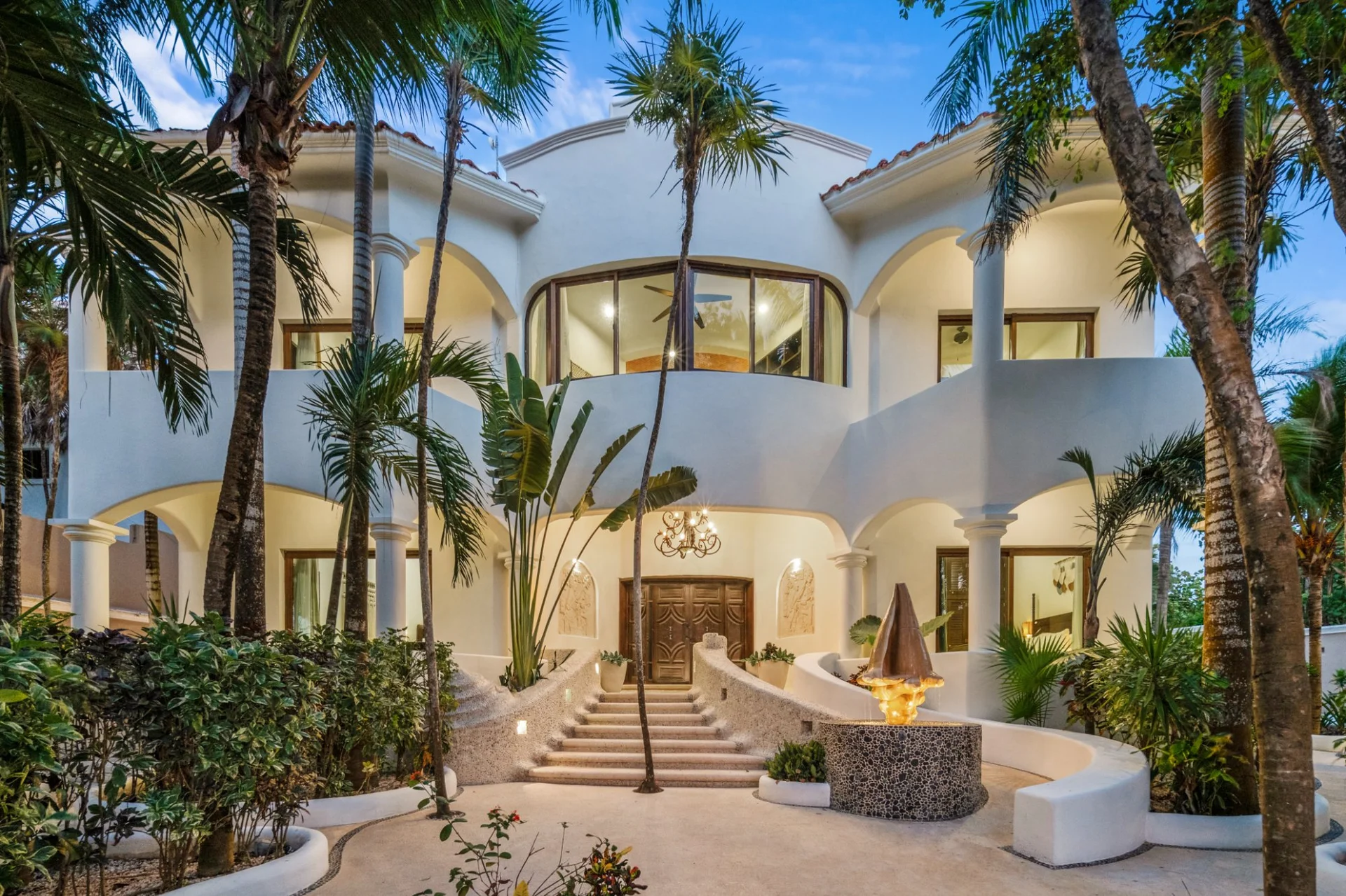 Hacienda Caracol facade and main entrance at night, luxury villa Bahía Soliman