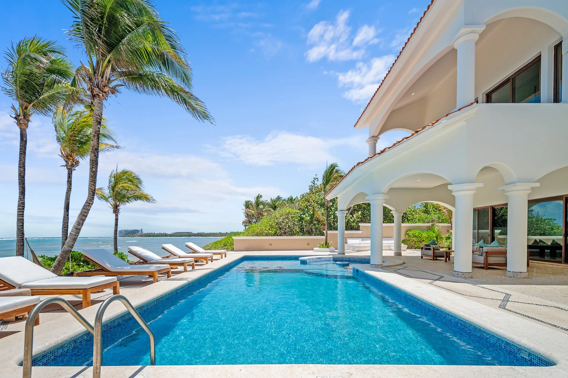 Private pool facing the sea with sun loungers at Hacienda Caracol, Bahía Soliman Tulum
