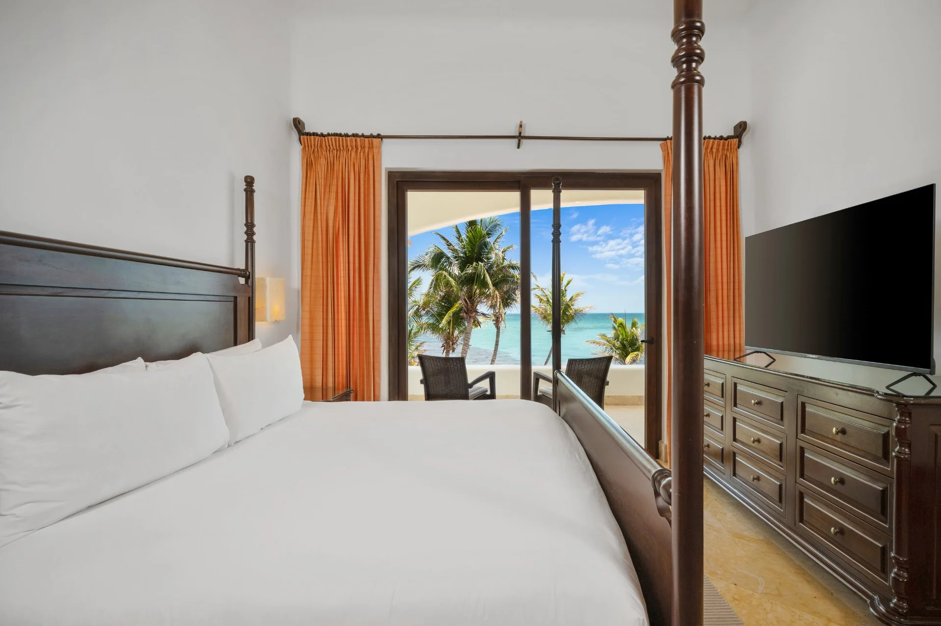 Bedroom with four-poster bed and Caribbean Sea view at Hacienda Caracol, Tulum