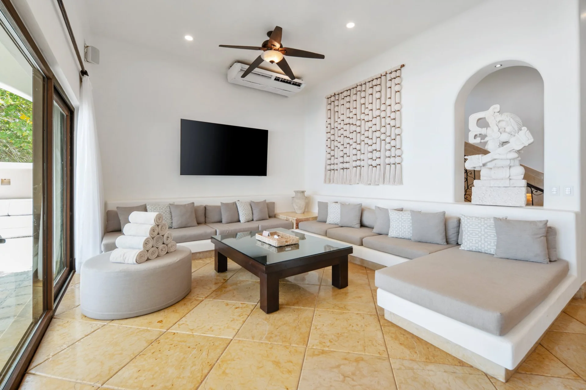 Sitting room with Mayan décor and sofas at Hacienda Caracol, luxury villa Tulum