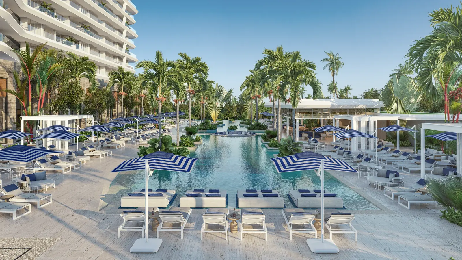 Alberca principal de Nautica Residences con camastros, sombrillas y palmeras frente a las torres, Cancún