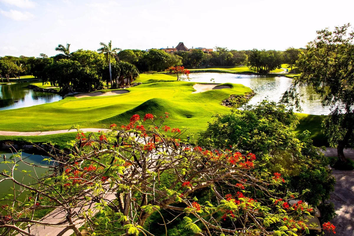Robert von Hagge 18-hole par 72 golf course in Playacar Playa del Carmen with lake and royal poinciana