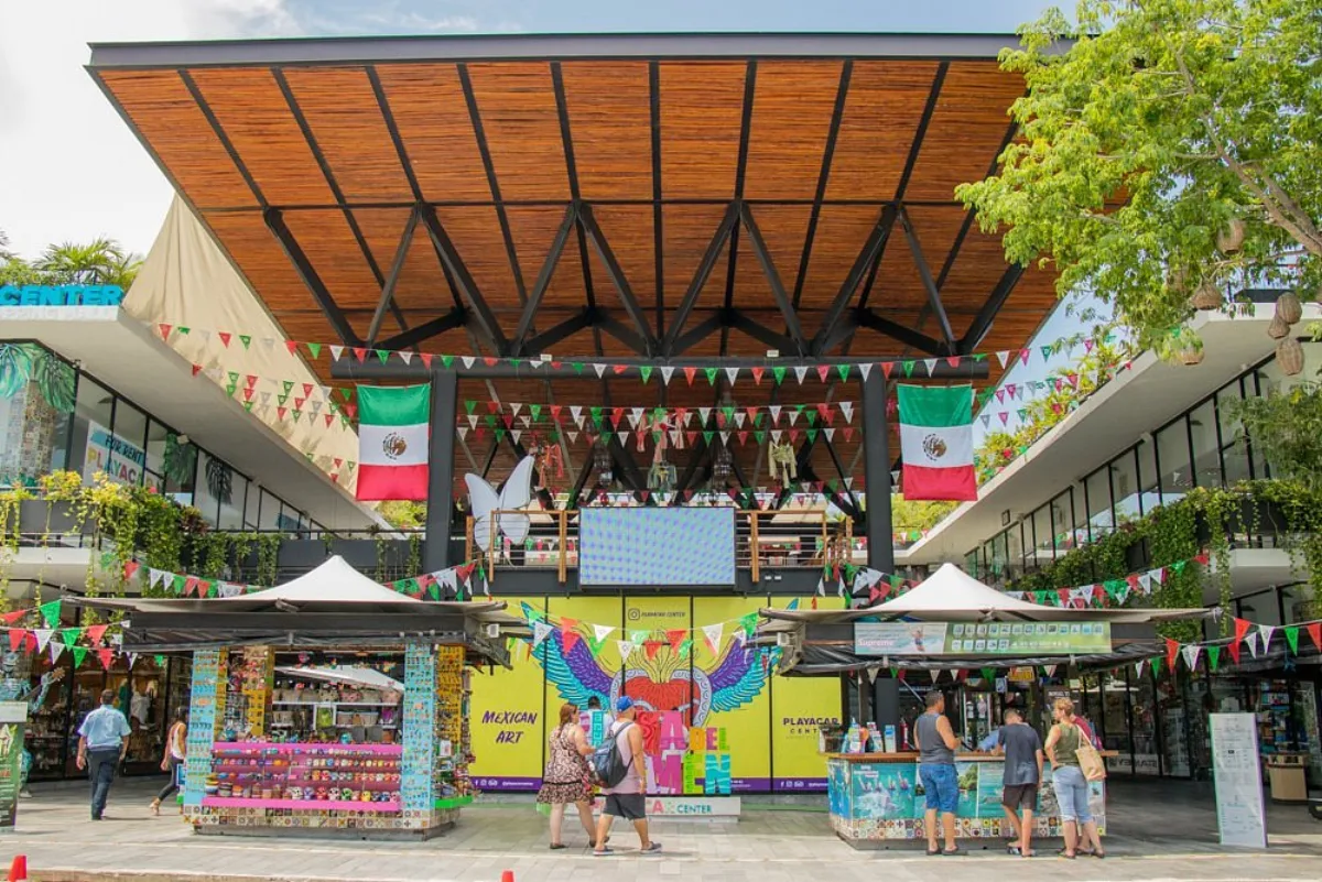 Plaza Playacar Center with wooden roof and colorful kiosks in Playacar Phase 2