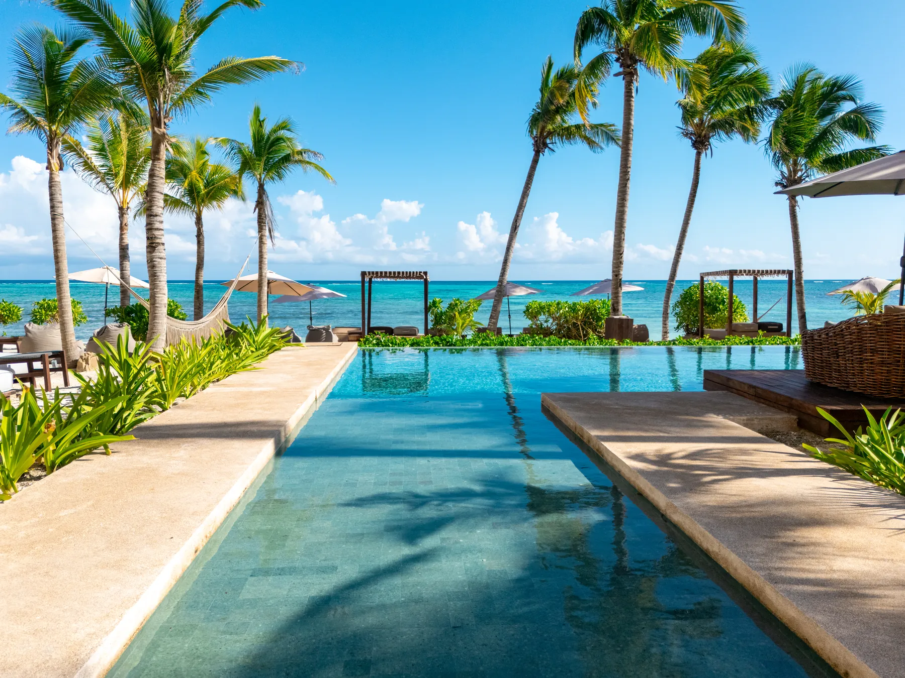 The Bespoke beach club: infinity pool overlooking the sea, with beach beds