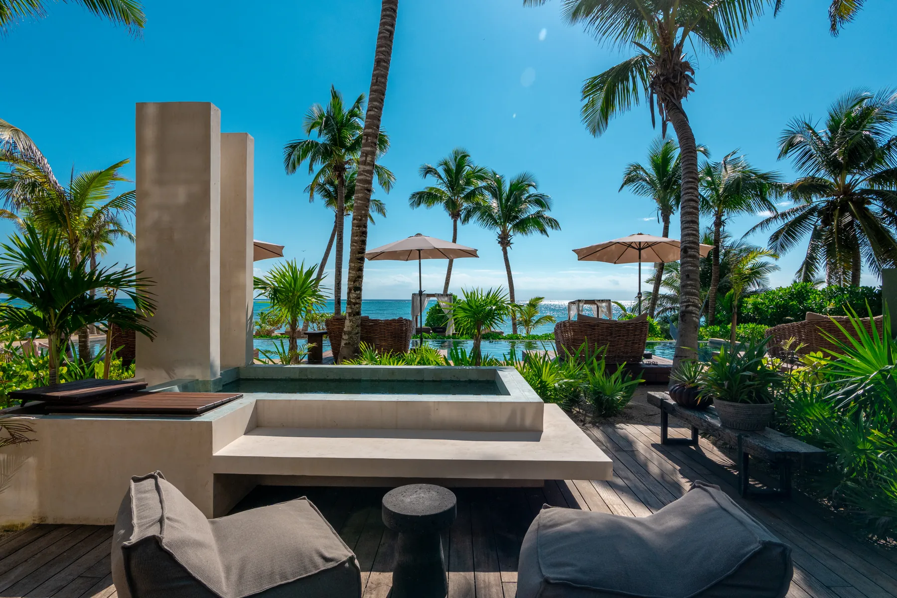 Villa 4: deck terrace with lounge seating and a private plunge pool; the beach club and the Caribbean Sea beyond